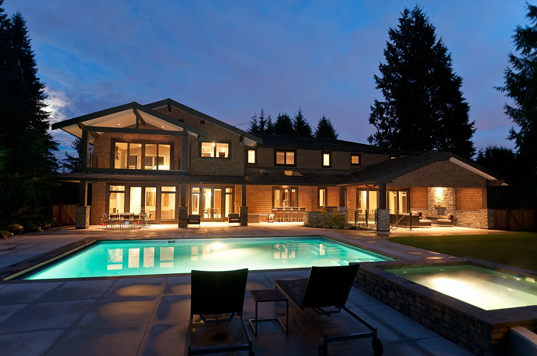 Custom home pool and terrace at twilight
